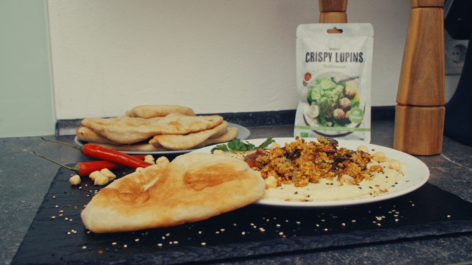 Hummus with a topping of CRISPY LUPINS Mediterranean with Balsamic-Infused Tomatoes and Fried Bread